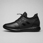 A black low-top sneaker shown in a side profile view against a neutral gray background.