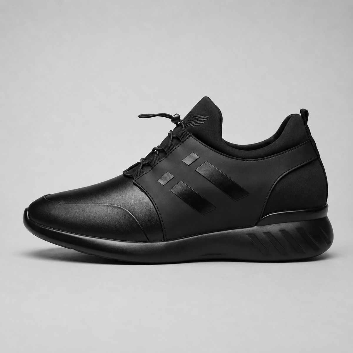 A black low-top sneaker shown in a side profile view against a neutral gray background.